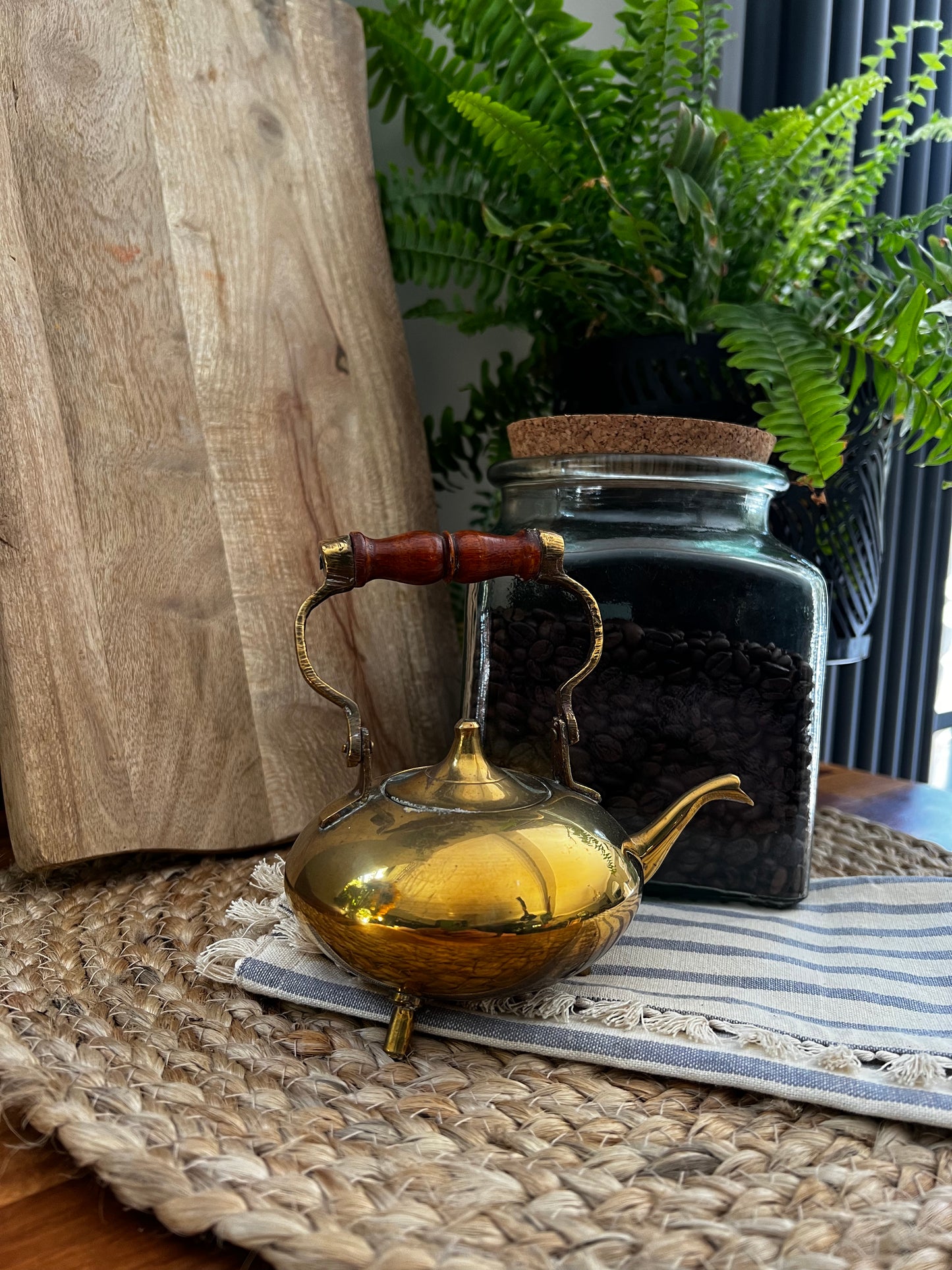 Small brass teapot with ornate wooden handle