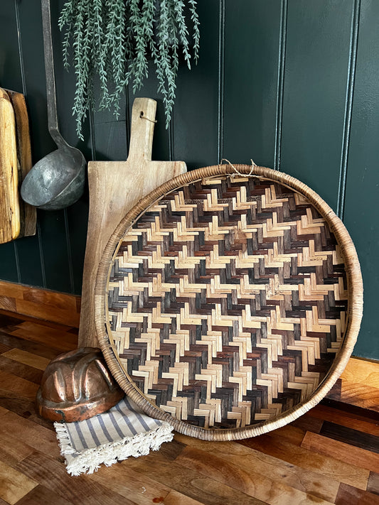 Woven round basket with herringbone pattern