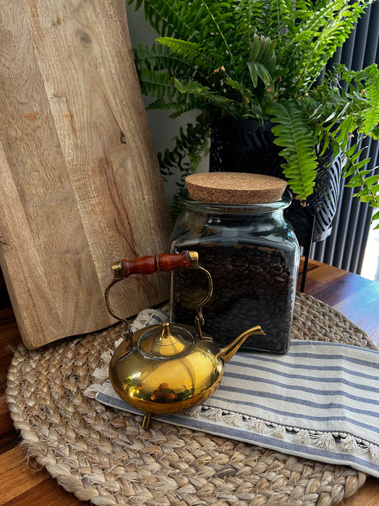 Small brass teapot with ornate wooden handle